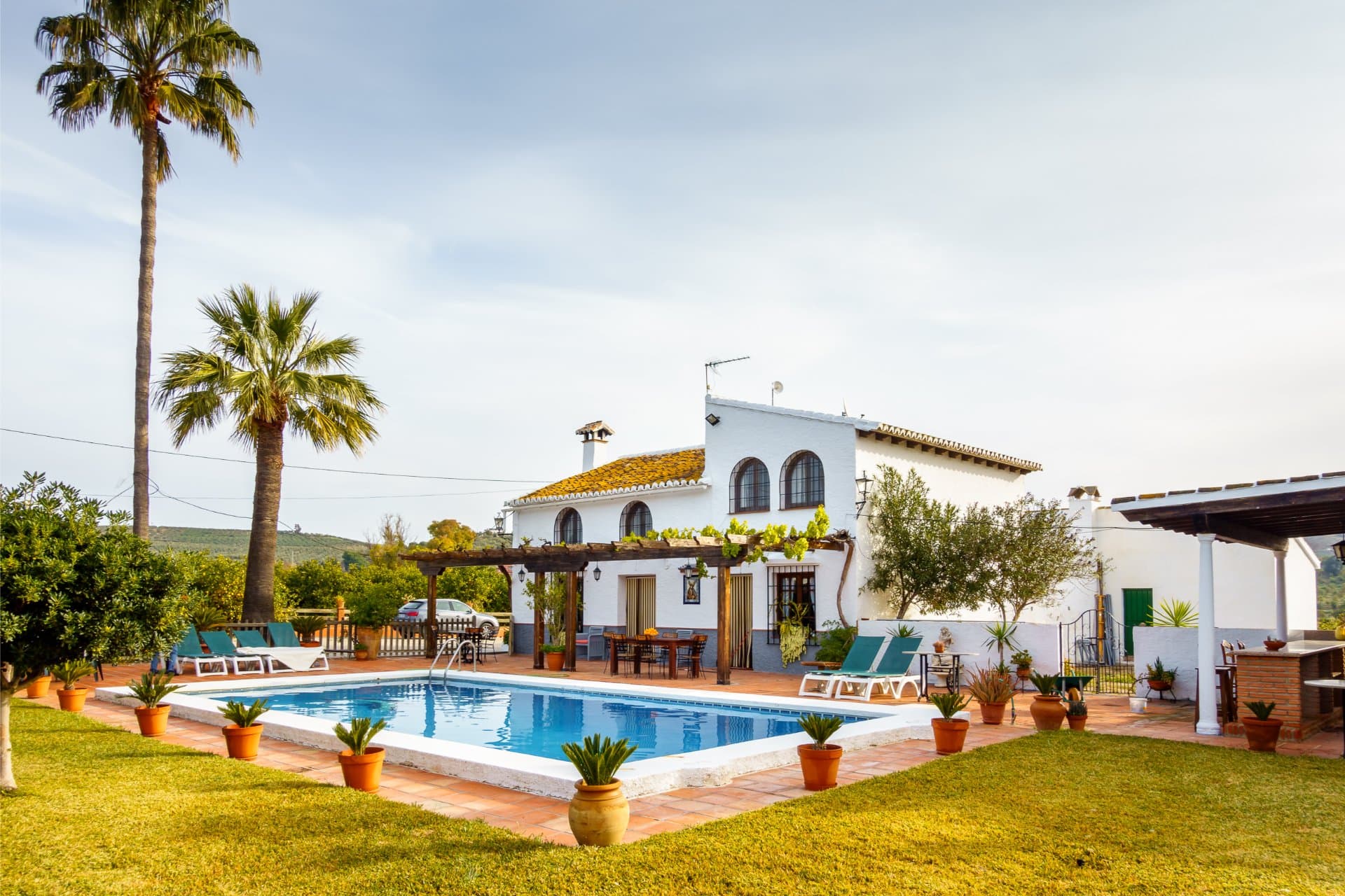 Iconic view of the white Andalusian villa standing tall against the blue sky.