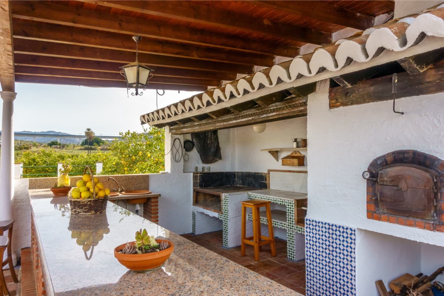 Outdoor kitchen space equipped for al fresco dining with mountain views.