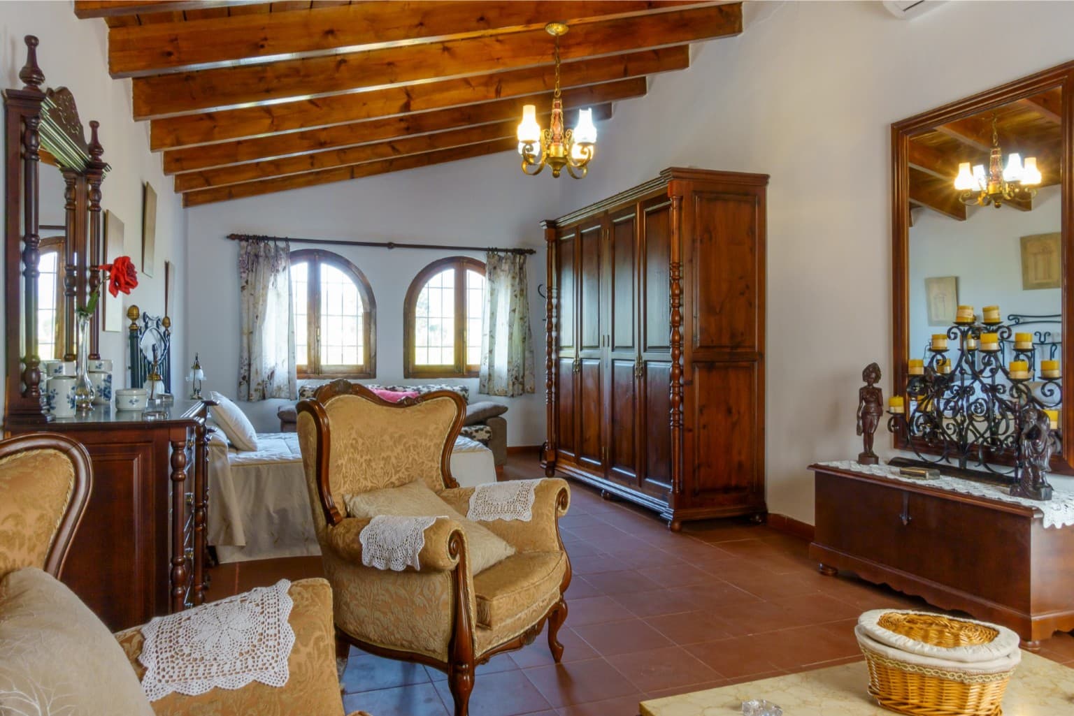 Dressing area with grand wooden wardrobes and antique mirror.