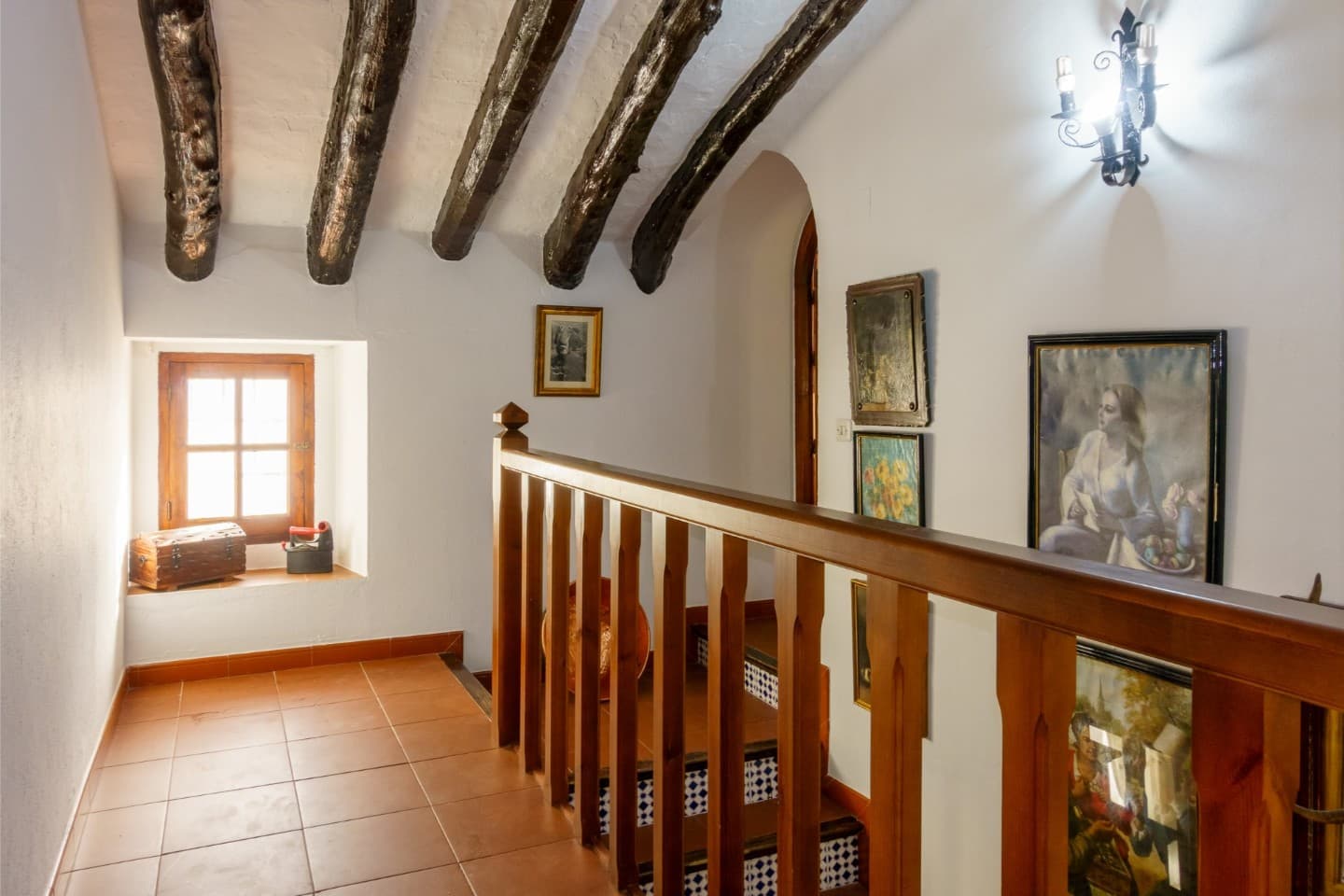 Charming upper hallway featuring authentic exposed wooden beams.