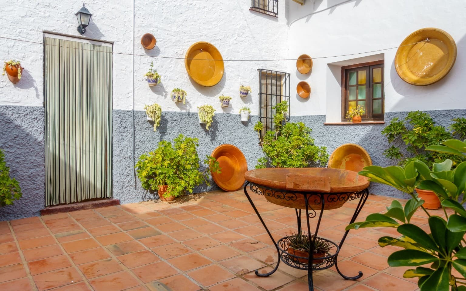 Patio walls decorated with traditional Spanish ceramic plates.