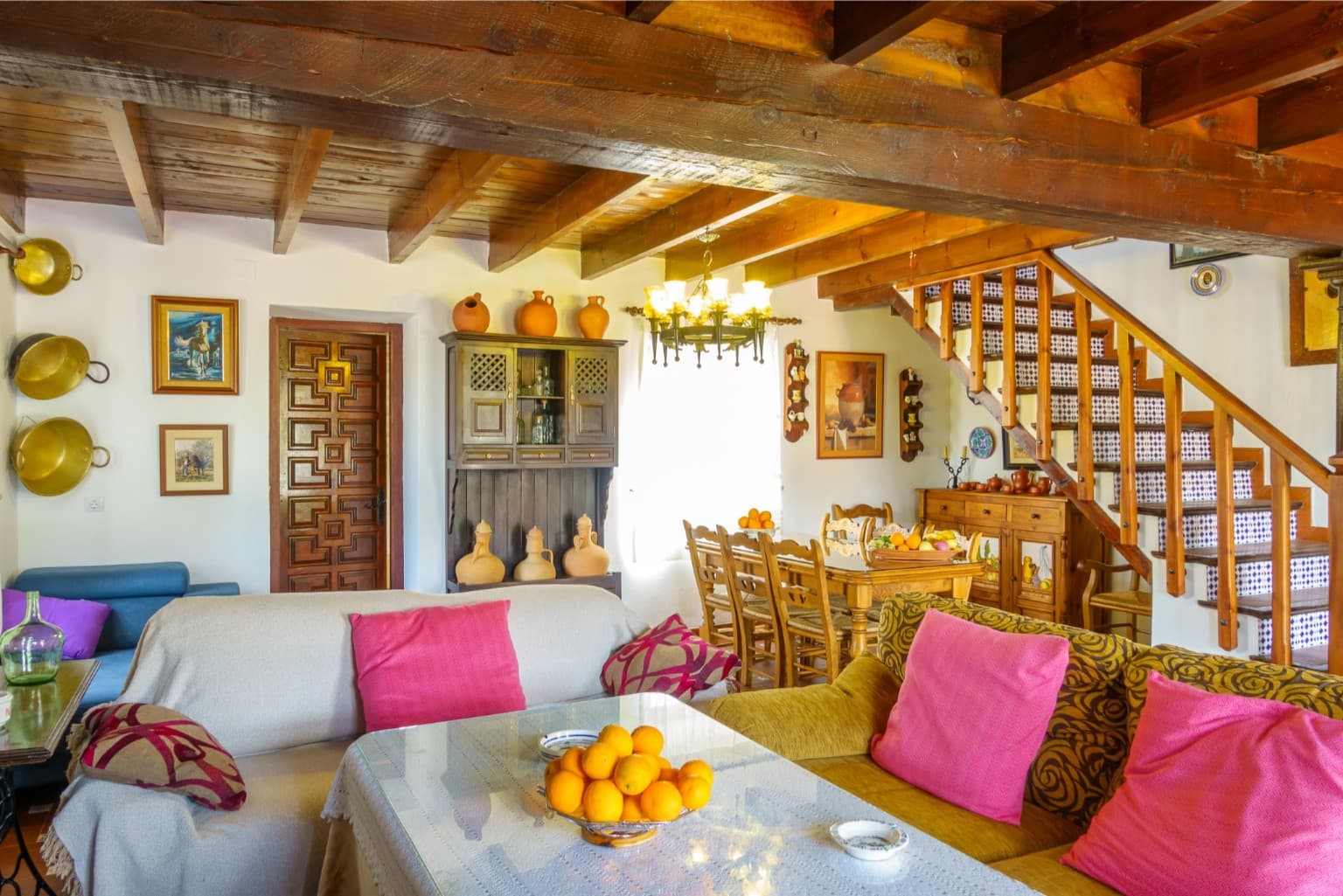 Spacious open-plan living area with a large wooden dining table.