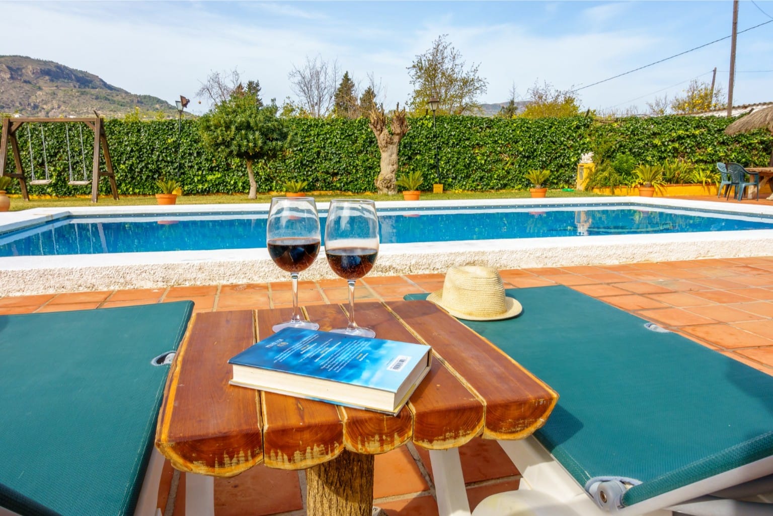 Perfect holiday moment relaxing by the pool with wine in total privacy.